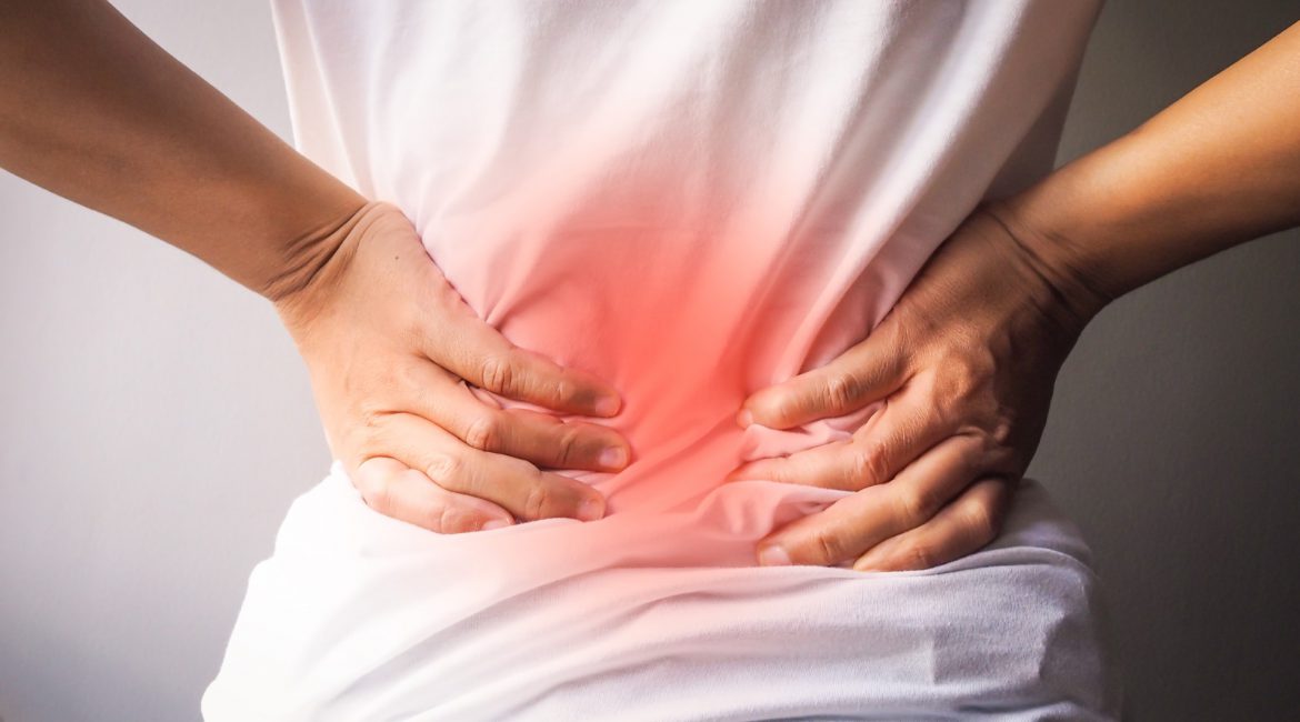 Woman's lower back with red pain highlight